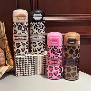 Detailed set of four stylish leopard print stainless steel tumblers with matching gift boxes