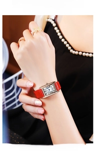 Detail of vintage square watch with red leather strap and roman numeral dial