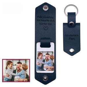 Detail of dark blue leather photo keychain with custom German text and silver snap button