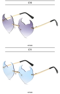 Detailed side view of rimless heart-shaped sunglasses with demon horns and metal frame