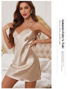 Close-up of champagne satin V-neck nightgown with delicate spaghetti straps and silky texture