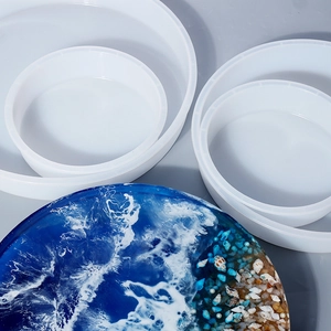 Detail of round silicone resin molds showing various sizes and finished ocean wave trays