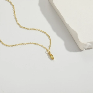 Elegant gold chain necklace featuring a yellow marquise shape gemstone pendant