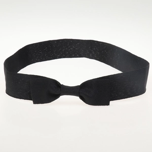 Detail of a soft black woven headband featuring a stylish central bow on a white background