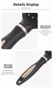Close-up of black ABS hairbrush with golden ring detail and round ergonomic handle