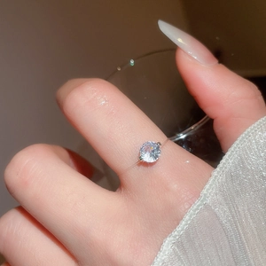 Macro shot of minimalist round brilliant-cut zircon ring with invisible transparent band