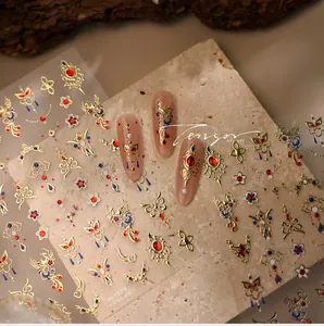 Detailed view of M-1324 gold phoenix nail art stickers with intricate embroidery patterns