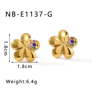 Detailed view of 18k gold plated flower stud earrings with vibrant inlaid gemstones