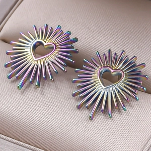 Detail of heart-shaped rainbow stainless steel stud earrings in a jewelry box