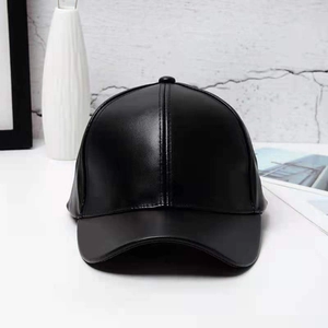 Detailed view of black PU leather baseball cap showing fine texture and stitching detail
