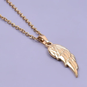 Detail shot of golden angel wing pendant on 18k gold plated stainless steel necklace
