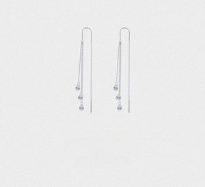 Detail of silver long tassel earrings with sparkling round cubic zirconia stones