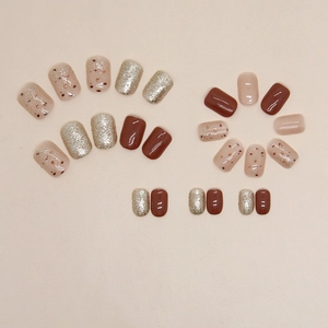 Short square press-on nails in caramel brown and champagne gold glitter finish