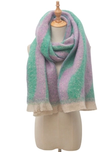Close-up of soft boucle knit scarf featuring purple and green wave patterns and beige tassels