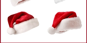 Detailed view of plush red and white Christmas hats with fluffy pom poms and soft texture