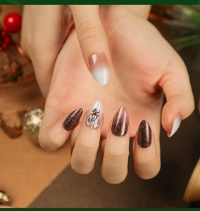 Festive almond press-on nails with brown glitter, ombre effect and 3D floral gemstone detail