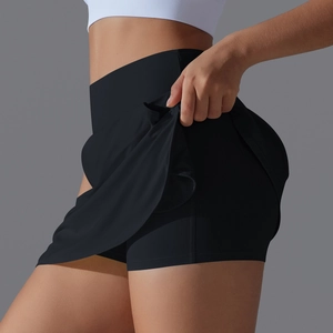 Detailed side view of high-waisted black tennis skort showing inner shorts and stretch fabric