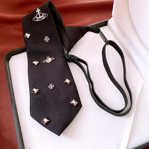 Detail of black adjustable tie necklace featuring silver planetary orbit and cross pendants