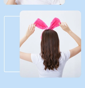 Rear view of a model wearing the soft pink plush rabbit ear headband for hair styling