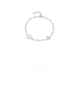 Close-up of S925 silver bracelet featuring white enamel daisy and paved zircon cross pendant