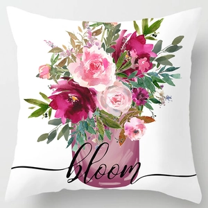 Detail of floral peach skin pillowcase with watercolor pink roses and 'bloom' lettering
