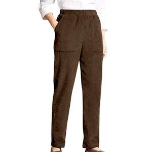 Macro detail of elastic waistband and corduroy texture on dark coffee casual pants