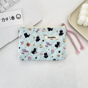 Close-up of quilted floral makeup bag with Lucky Kitten print and a pink rope zipper