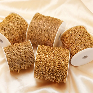 Five rolls of golden stainless steel flat side chains for DIY jewelry making on silk