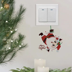 Detail of Santa Claus wall sticker with Merry Christmas text near a light switch