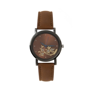 Detail of vintage brown leather watch featuring gold floral dial and blue hands