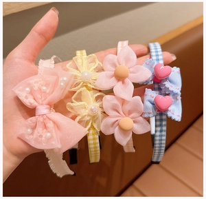 Detail view of four colorful lace and plaid bow headbands with pearl accents for girls