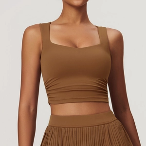 Detail view of caramel brown square neck crop top with side pleats and ribbed texture
