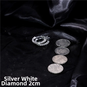 Macro detail of 2cm silver hoop earrings with white rhinestones on black satin