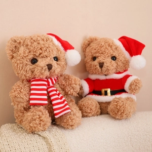 Charming plush Christmas teddy bears with Santa hat, scarf and coat on a cozy knit blanket