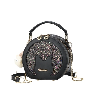 Minimalist cat-shaped round crossbody bag with black sequins and a metal chain strap