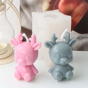 Close-up detail of deer-shaped silicone mold and finished pink and grey scented candles