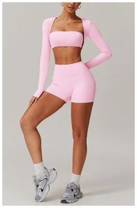 Three-piece pink yoga set with zip-up cardigan, sports bra, and high-waist shorts