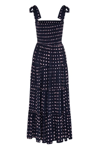 Detailed view of navy summer dress with pink square dots and smocked bodice detail