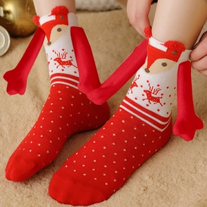 Detail of Christmas themed 3D fox magnet socks with reindeer patterns on model's feet