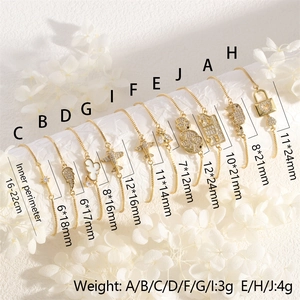Detailed view of ten gold-plated charm bracelets with star, heart, and elephant pendants
