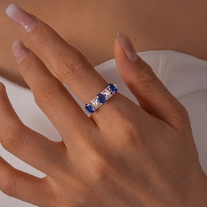 Macro detail of vintage silver ring featuring oval blue zircons and clustered white stones
