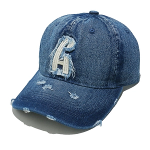 Distressed blue wash denim baseball cap with white embroidered letter R and ripped details