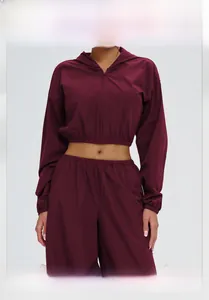 Close-up of wine red sports jacket with elastic hem and high-quality zipper detail