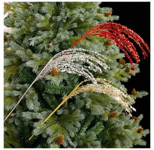 Detail of red, gold, and silver glitter decorative branches on a green Christmas tree