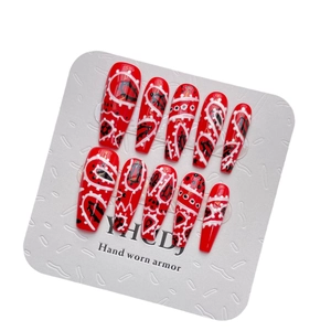 Handmade red long coffin press-on nails with white wavy patterns and artistic polka dots