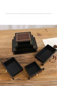 Close-up of three-tier vintage wooden book-shaped storage boxes with drawer functionality