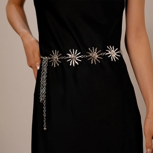 Vintage silver sun medallion waist chain on black dress with pleated metal finish