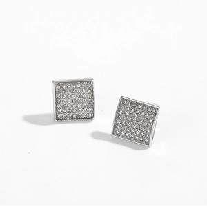 Macro shot of silver square stud earrings with crystal pave settings on white background