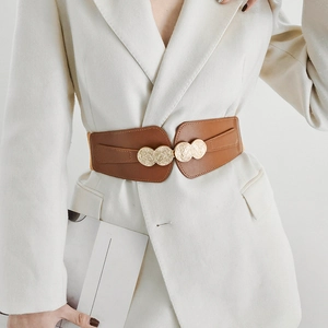 Close-up of brown elastic wide belt with a vintage gold round metal buckle for dresses