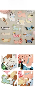 Detailed embroidery view of cartoon dog and cat iron-on patches with adhesive backing